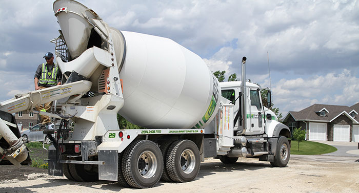 A concrete worker recycling concrete at a construction site.