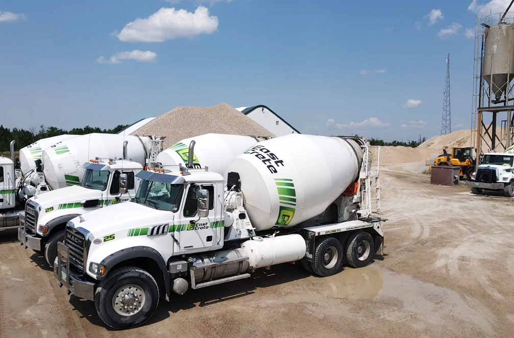An image of concrete trucks loading ready-mix concrete.